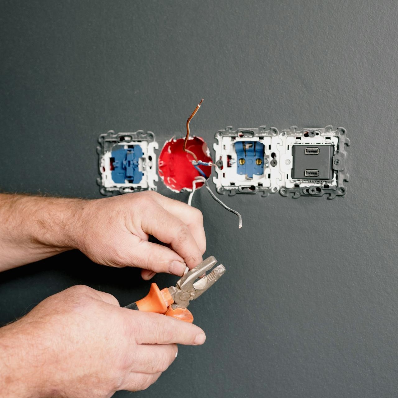 Electrician working on a wall