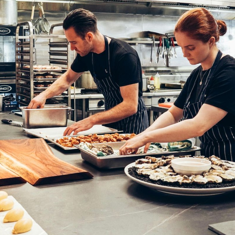 Employees preparing food in a kitchen